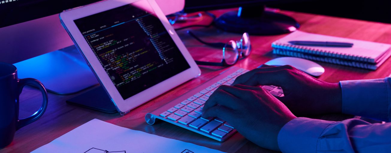 Close-up image of programmer working at his desk in office