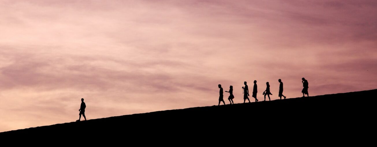 silhouette of people on hill