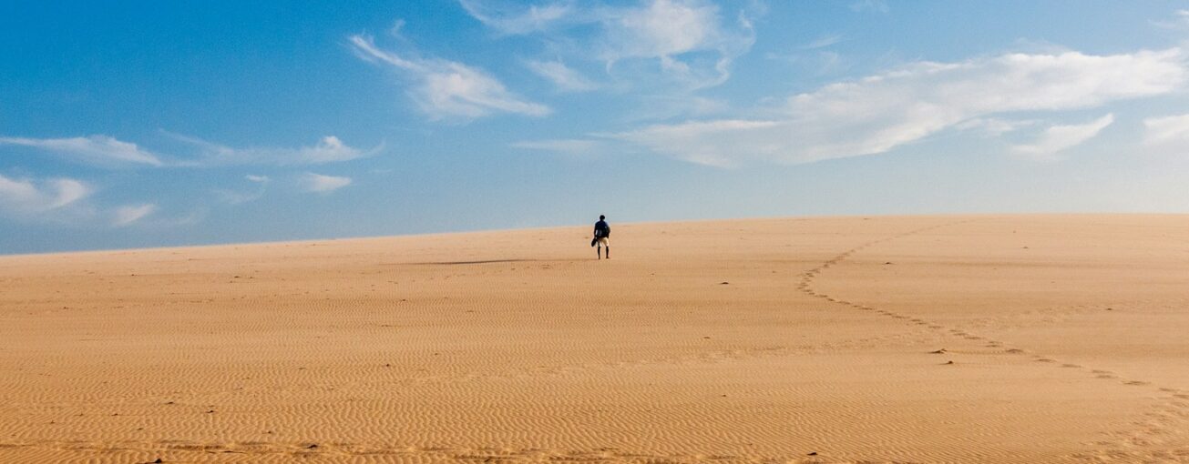 person standing on desert at daytime