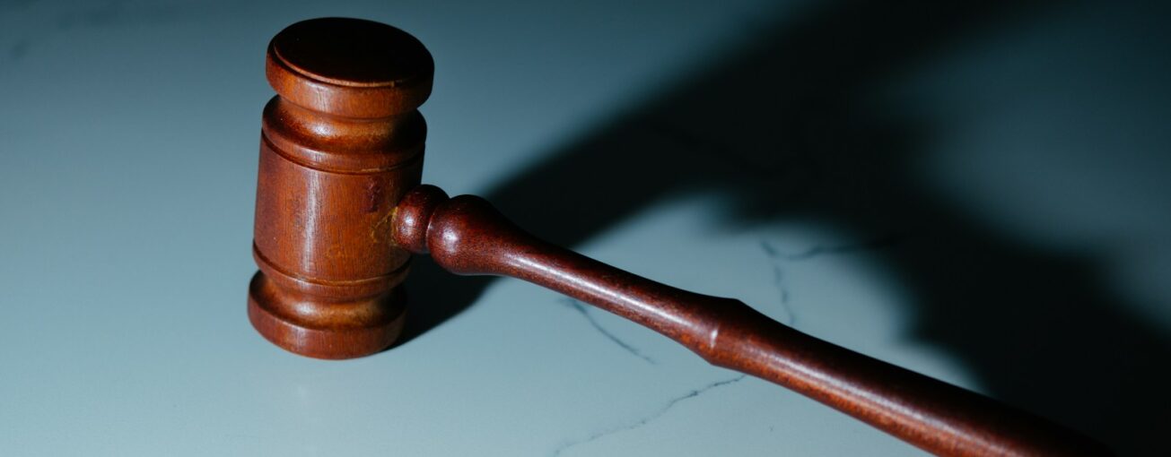 a wooden judge's hammer sitting on top of a table